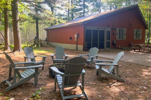 a group of chairs and tables in front of a building at Northwoods Resort in Woodruff
