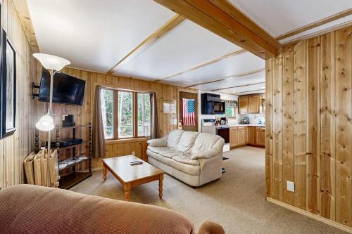 a living room with a couch and a table at Quaint Lake Escape in Eagle River