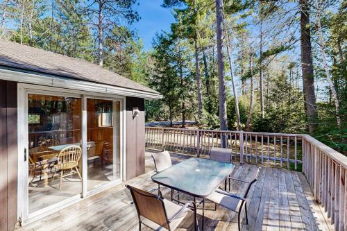 a patio with a table and chairs on a deck at Quaint Lake Escape in Eagle River