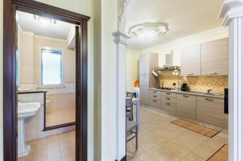 a bathroom with a sink and a toilet in a room at Casa Amica in Avola