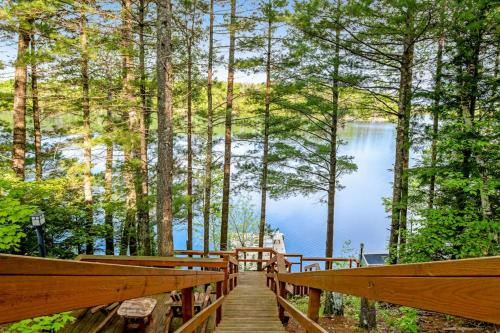 a wooden walkway leading to a lake in the woods at Loon's Landing in Mercer