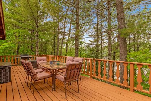 a wooden deck with a table and chairs on it at Loon's Landing in Mercer