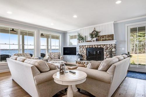 a living room with two couches and a fireplace at Summer Breeze in Sayner
