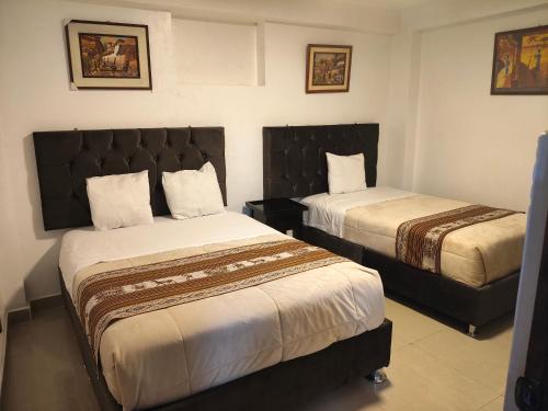 a hotel room with two beds in a room at Hostal Ñustas INN in Machu Picchu