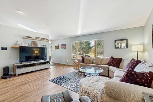 a living room with a couch and a tv at Par for the Course in New Rome