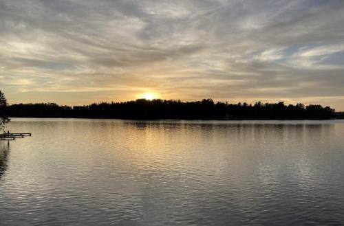 a large lake with the sun setting in the distance at Turtle Bay in Minocqua