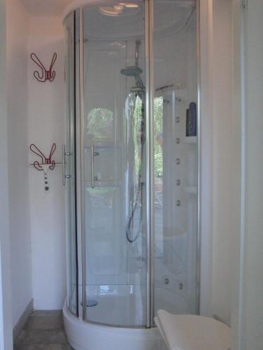 a shower in a bathroom with scissors on the wall at Ferientraum Kobellstrasse in Rottach-Egern