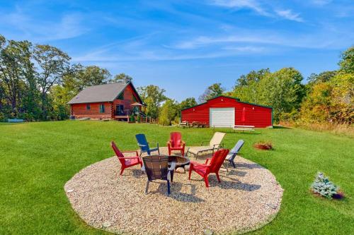 a patio with chairs and a table and a red barn at Blissful Deer Cabin in Friendship