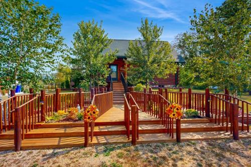 a wooden deck with flowers on it in front of a house at Blissful Deer Cabin in Friendship