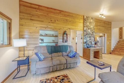 a living room with a couch and wooden walls at Tall Pines in Woodruff