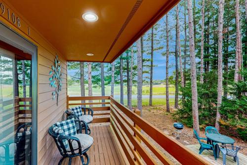 a porch with chairs and a view of the woods at Knotty Pines in Wisconsin Dells