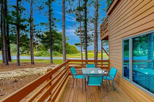 a patio with a table and chairs on a deck at Knotty Pines in Wisconsin Dells