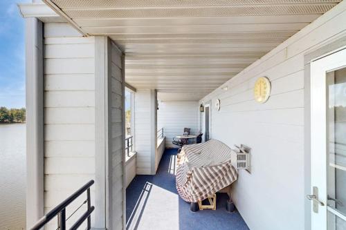 a porch of a house with a table and chairs at Lighthouse Cove Condo Resort: 418 in Wisconsin Dells