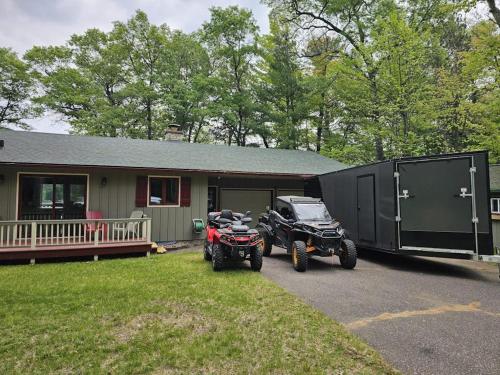 two atvs parked in front of a house at Hooked on Johnson in Arbor Vitae