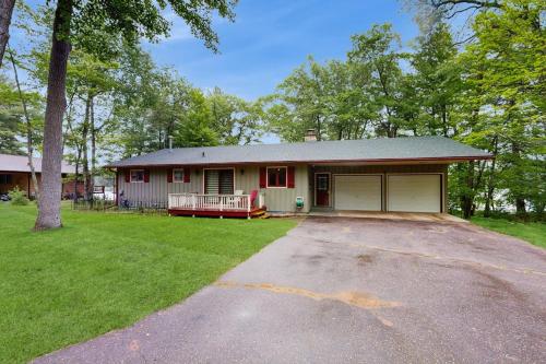 a house with a driveway in front of it at Hooked on Johnson in Arbor Vitae