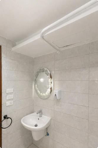a white bathroom with a sink and a mirror at Luxurious Beachfront Apartment in Alexandria