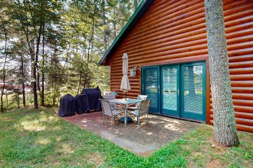 a patio with a table and chairs next to a house at The Aspen in Mercer