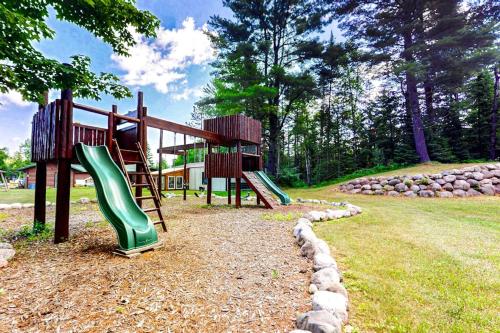 a playground with two slides in a park at Pine Tree House in Mercer