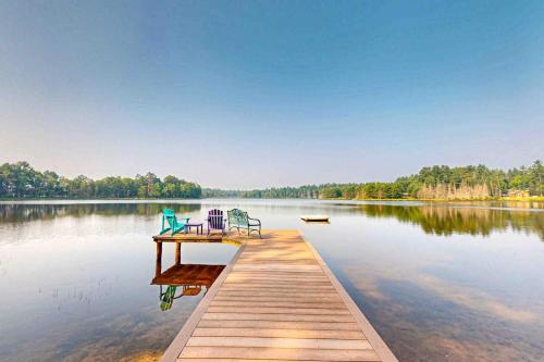 two chairs on a dock on a lake at Shangri La in Eagle River
