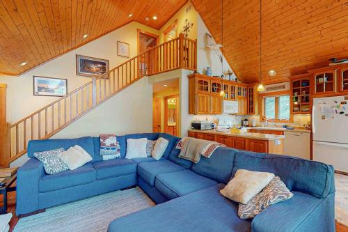 a living room with a blue couch in a kitchen at Shangri La in Eagle River