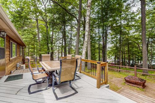 a wooden deck with a table and chairs on it at Wild Bear Retreat in Saint Germain