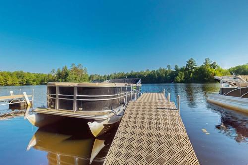 a boat is docked at a dock on a lake at Gateway Lodge in Mercer