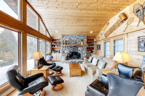 a living room filled with furniture and a fireplace at Bayside Secret in Phelps