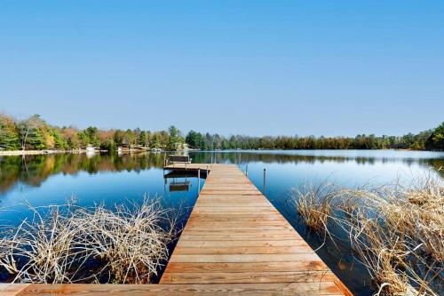 a wooden dock in the middle of a lake at Blissful St Germain Retreat in Saint Germain