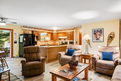 a living room with two chairs and a table at Northwoods Paradise in Eagle River