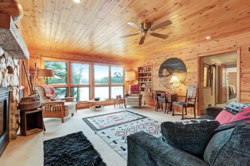a living room with a couch and a ceiling fan at Hotter's Cabin in Eagle River