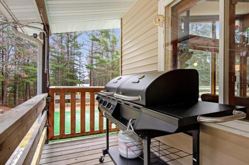 a grill on the porch of a house at Catfish Lake Home in Eagle River
