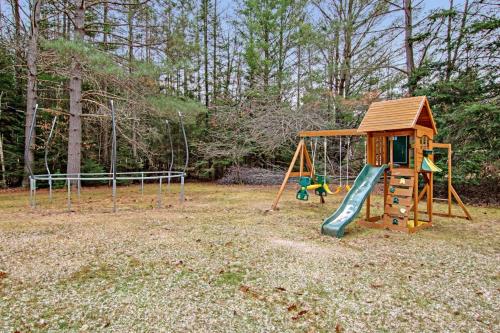 a playground with a slide and a swing at Catfish Lake Home in Eagle River