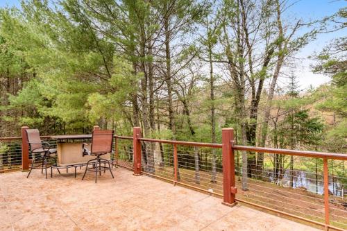 a patio with two chairs and a table on a fence at One Acre Wood in Eagle River