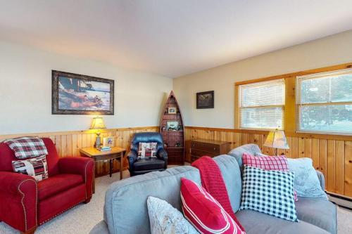 a living room with a blue couch and a red chair at Briar's Hideaway in Phelps
