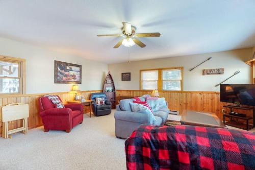 a living room with a couch and a ceiling fan at Briar's Hideaway in Phelps