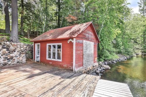 a red building on a dock next to a river at Casa Maria in Mercer