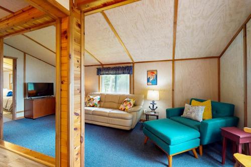 a living room with a couch and a tv in a room at Catfish Cottage B in Eagle River
