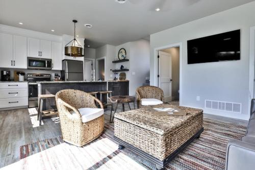 a living room with a couch and chairs and a kitchen at The Studio in Minocqua