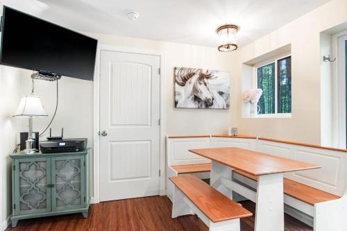a dining room with a table and a television at Cove View in Minocqua