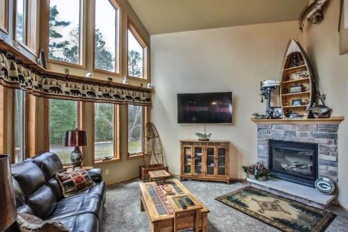 a living room with a couch and a fireplace at Copperwood #1 in Eagle River