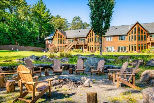 a house with chairs and a fire pit in the yard at Copperwood #1 in Eagle River