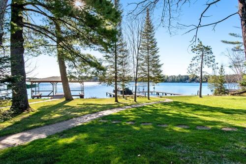 a park with trees and a lake in the background at Copperwood #4 in Eagle River