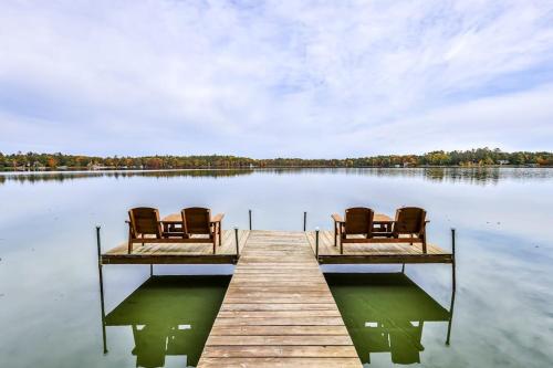 two chairs sitting on a dock on a lake at Tranquility Base in Rhinelander