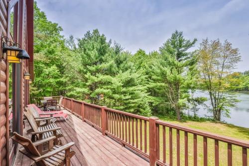 a deck with chairs and a view of a lake at Northwoods Getaway in Arbor Vitae