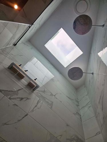 a ceiling view of a shower with a window at Hill Top Park - Apple Tree Studio in Kilmore