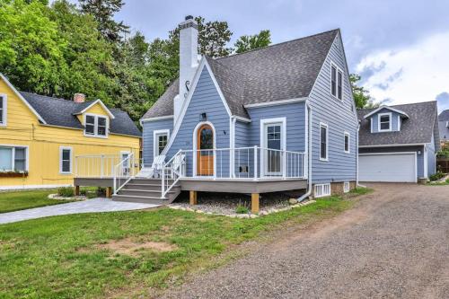 a blue house with a porch and a yellow house at The Catalog Cottage in Minocqua