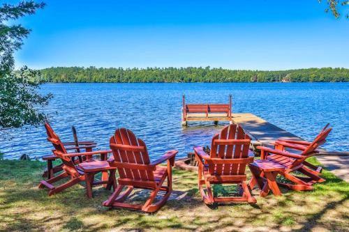 a group of chairs sitting on the edge of a lake at The Nut House in Eagle River