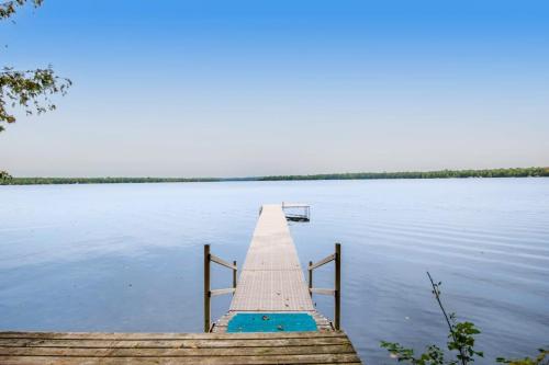 a dock in the middle of a body of water at Ashton House in Phelps