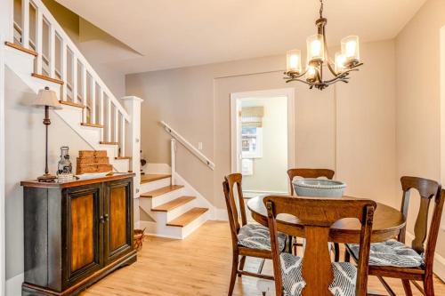 a dining room with a table and chairs and stairs at The Blue Cottage in Minocqua