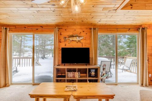 a living room with a tv and a table at The Haven in Eagle River